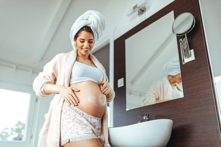 Pregnant woman taking care of her skin