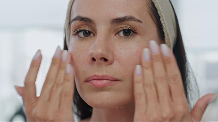 woman checking her skin for signs of retinol peeling