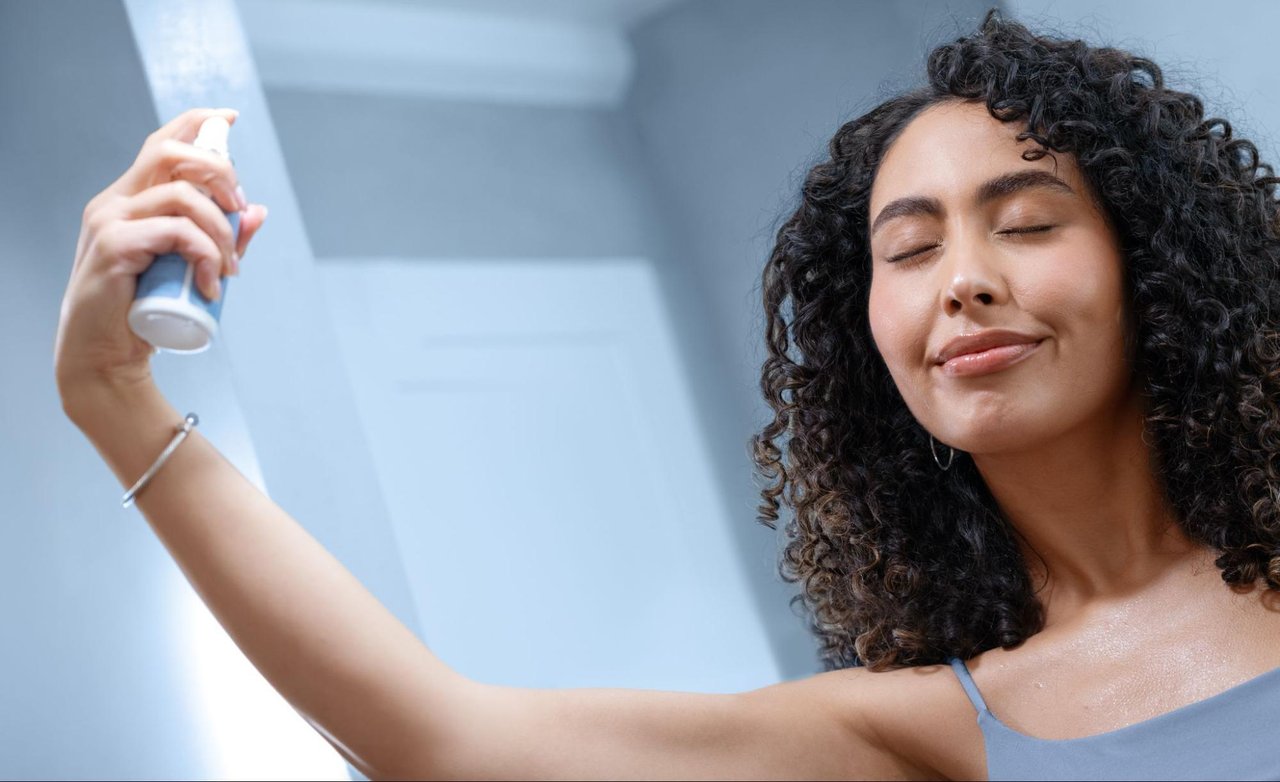 woman spraying cbd skin mist to help refresh oily skin