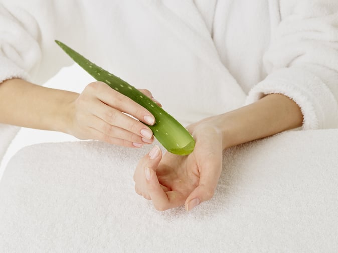 Woman using aloe vera for skincare