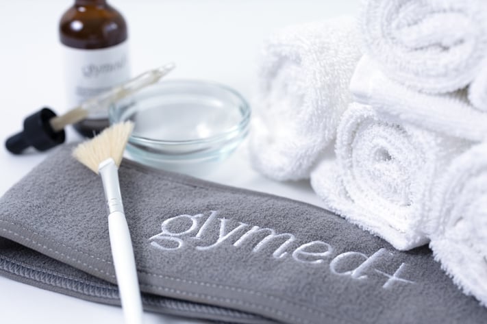 glymed+ skincare treatment supplies with towels, applicator brush and serum