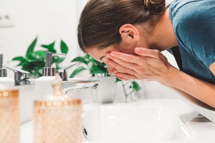 Woman washing her face